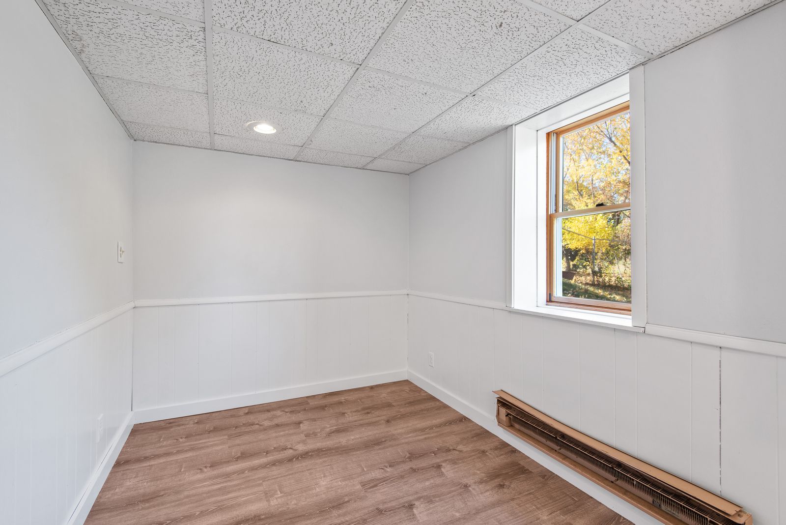 Empty room with wood floors before staging
