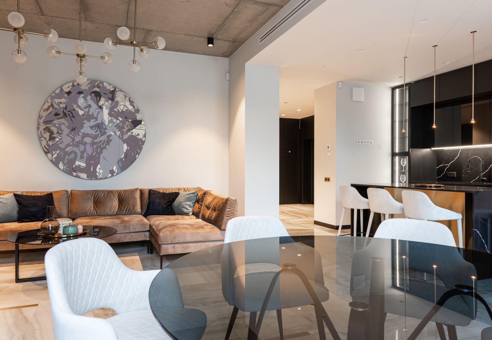 Staged living room with neutral decor and open kitchen